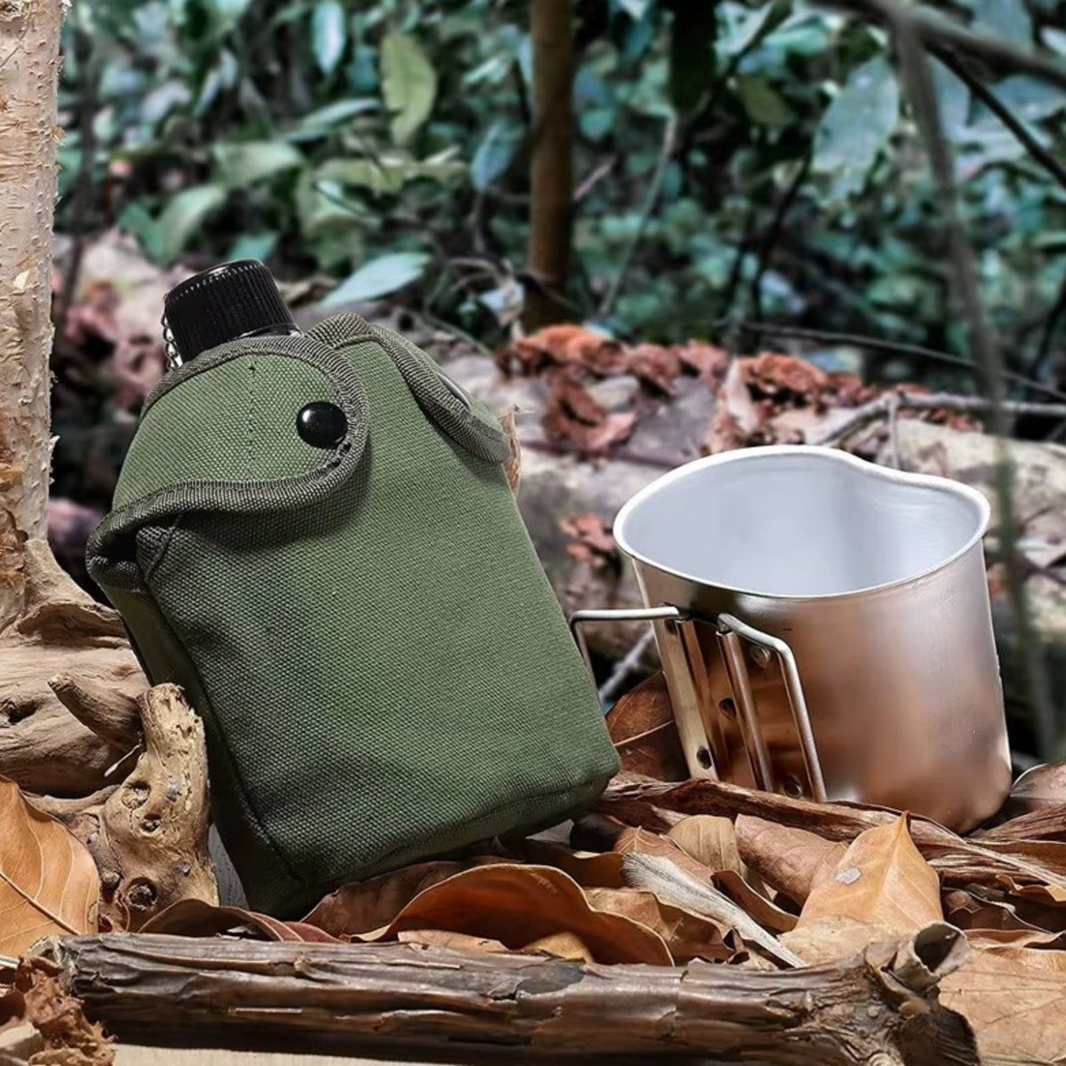 The canteen in its green cover and the cup on the forest floor