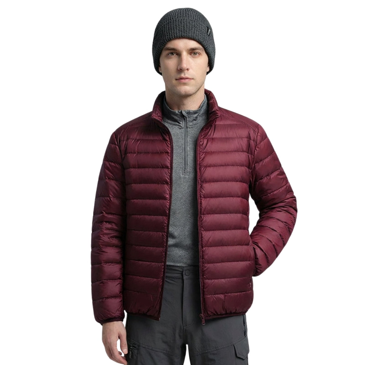 Man wearing the burgundy lightweight puffer jacket open over a grey zip-neck top, front view