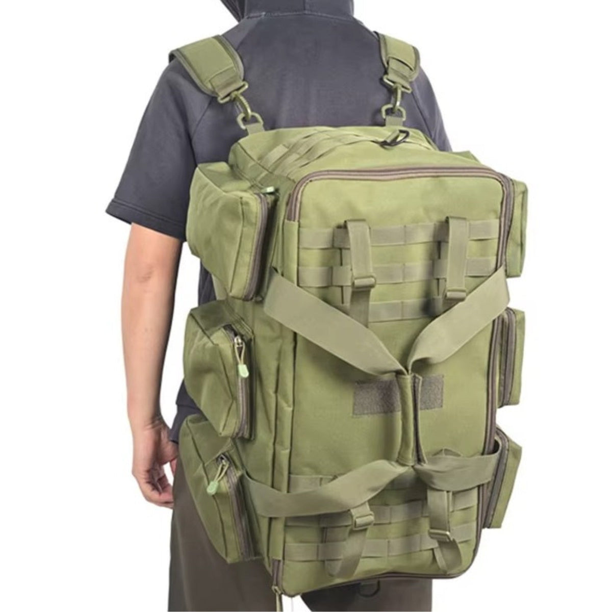 Man carrying the olive green duffel as a backpack, back view