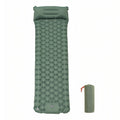 Sage green inflatable sleeping mat with built-in pillow seen from above, beside its drawstring storage bag