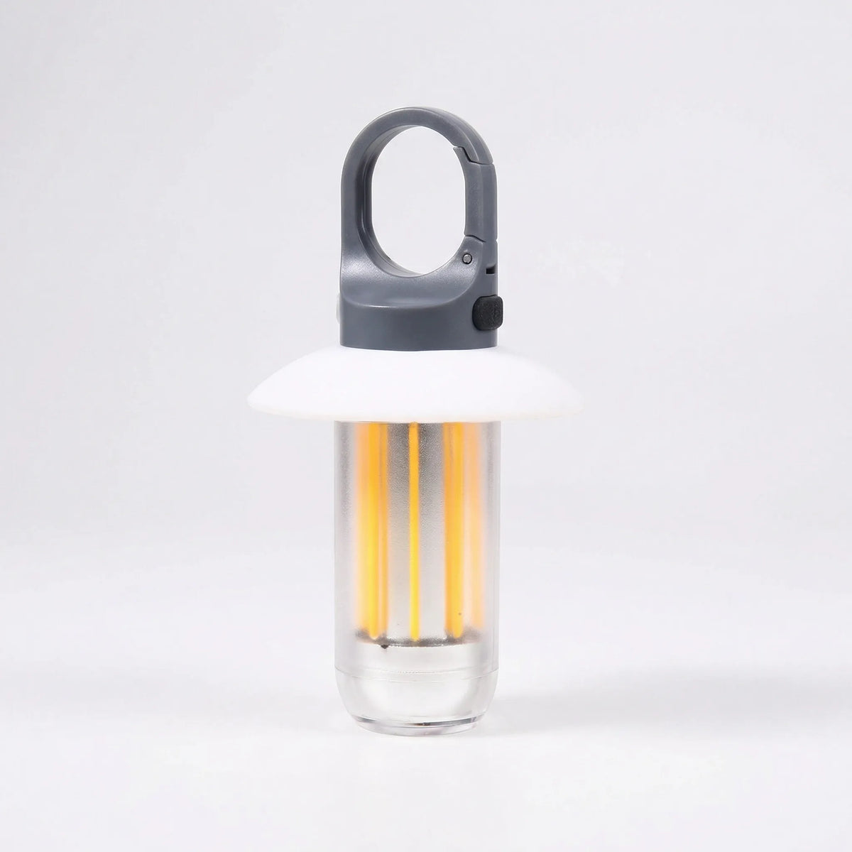 Camping lantern lit, grey clip hook and cap, white shade and clear tube with warm LED strips, on a light grey background