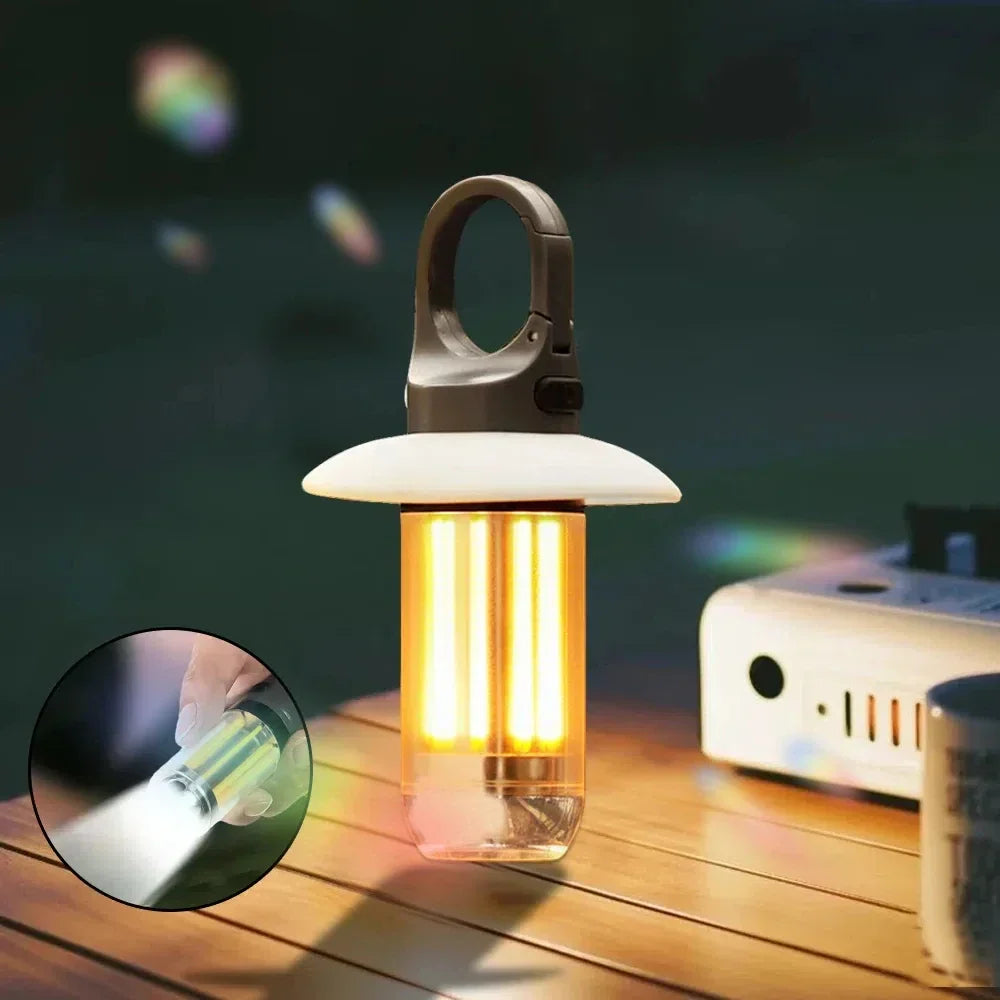 Lit camping lantern on a wooden table at night, with an inset of the white torch beam from its base
