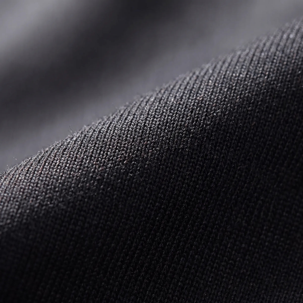 Close-up of the black stretch knit fabric of the thermal base layer