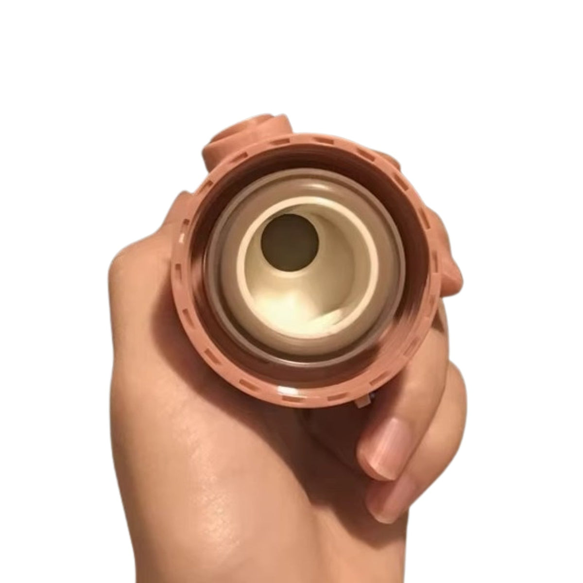Hand holding the unscrewed lid unit, showing its seal and spout from below