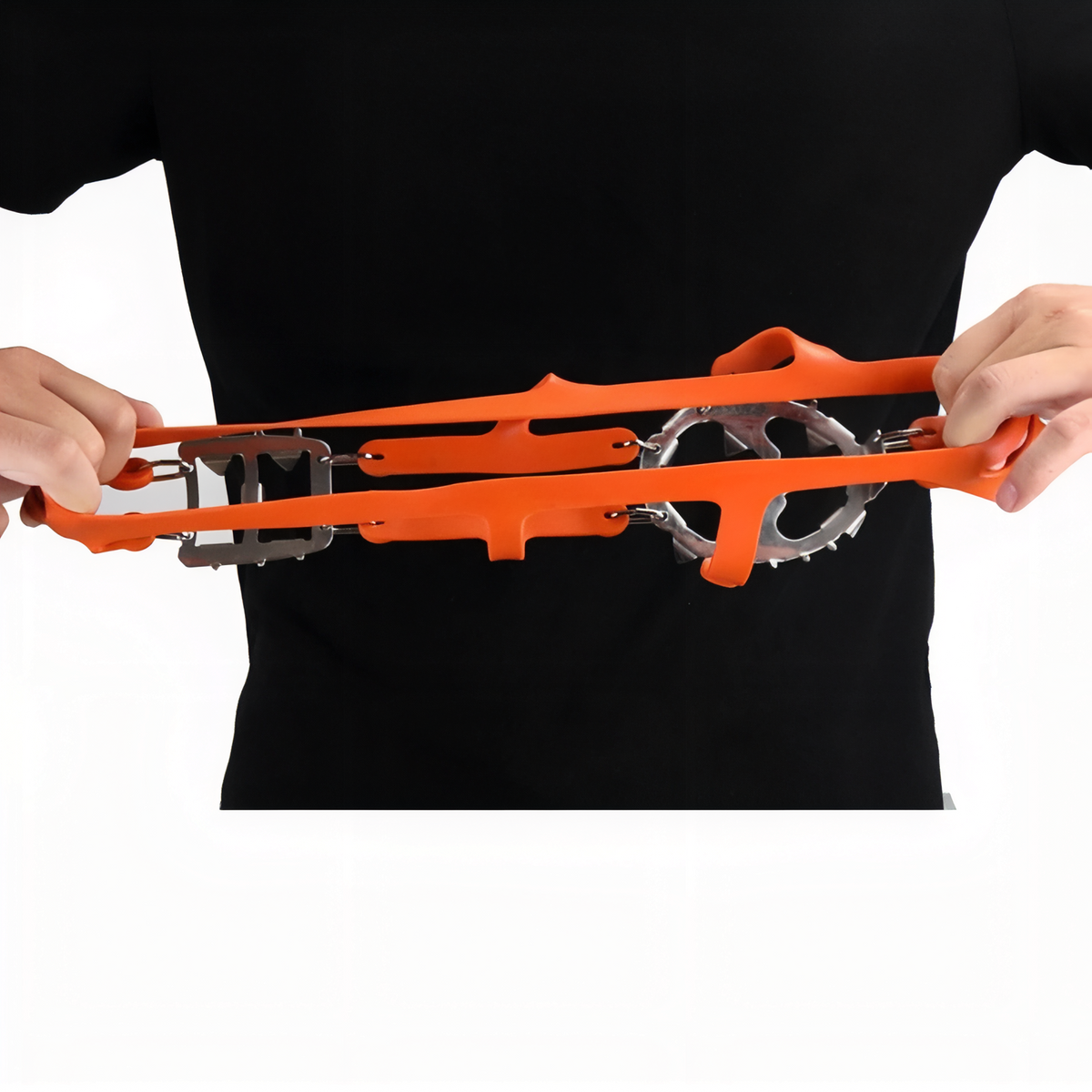 Orange silicone crampon harness stretched between two hands to show how far it gives