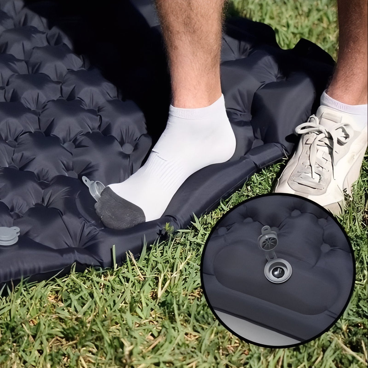 Foot pressing the built-in foot pump of the charcoal grey mat, with an inset of the valve