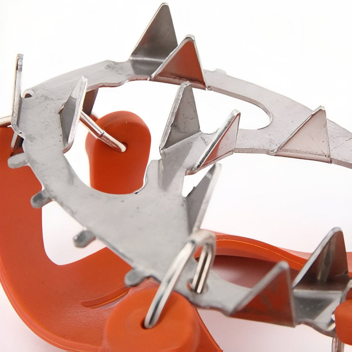 Close-up of the stainless steel spike plate on the orange silicone harness