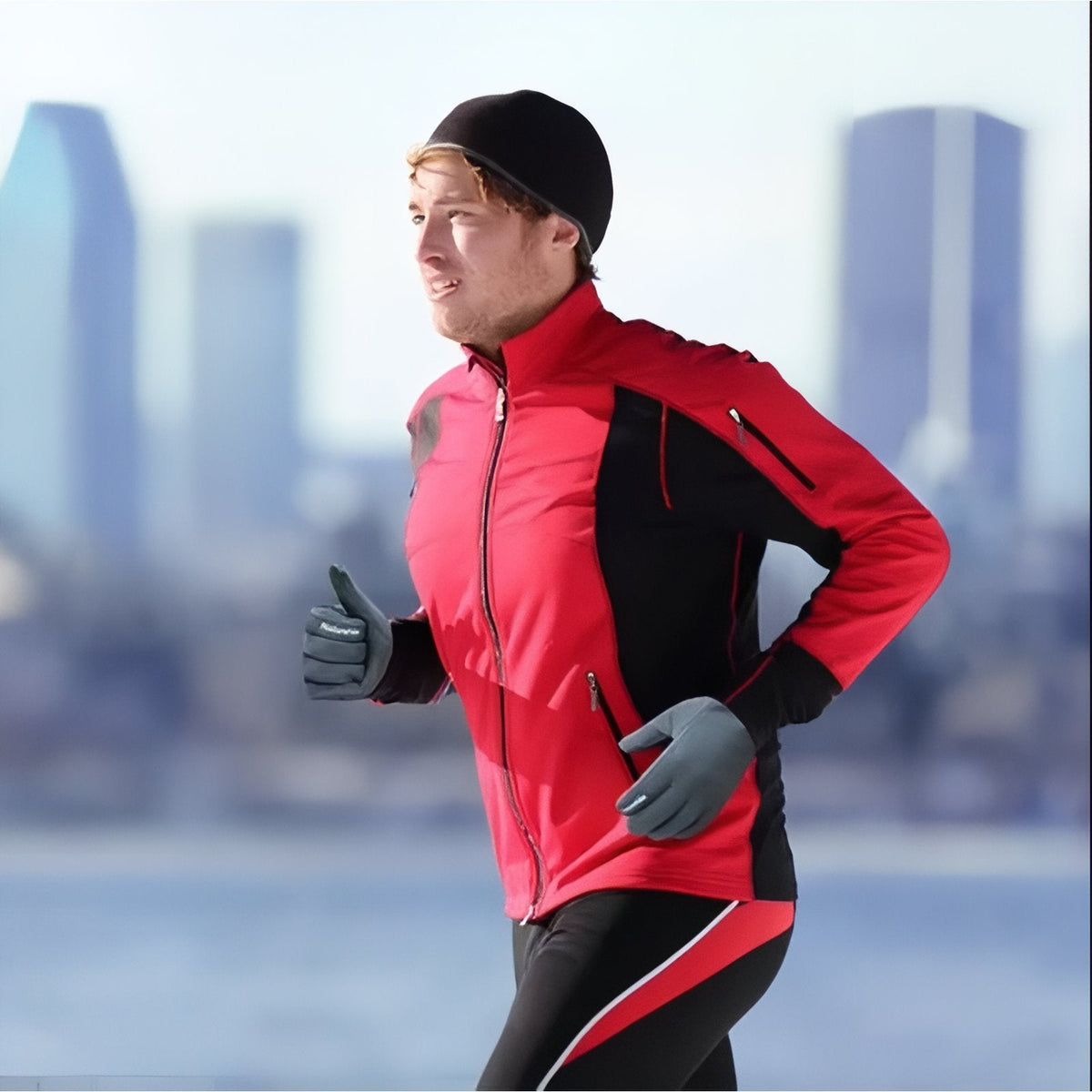 Runner in a red jacket on a winter waterfront, wearing grey touchscreen gloves
