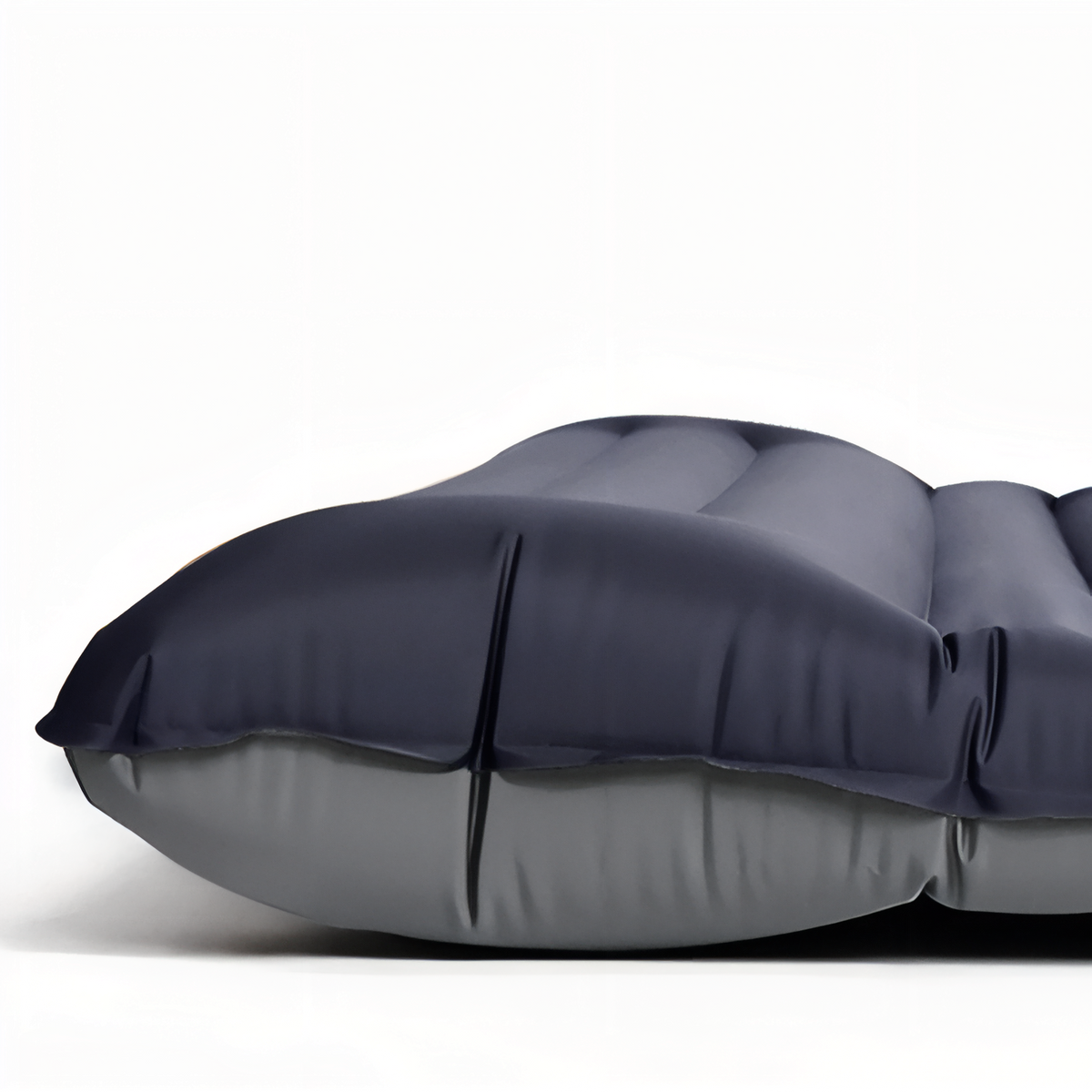 Close-up of the raised head section of the black inflatable mat