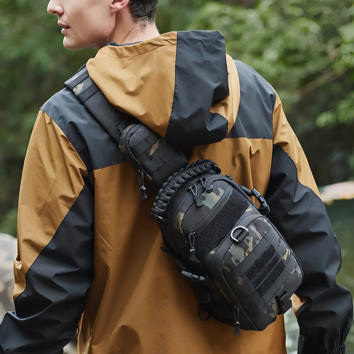 Man wearing the sling bag on his back by a river