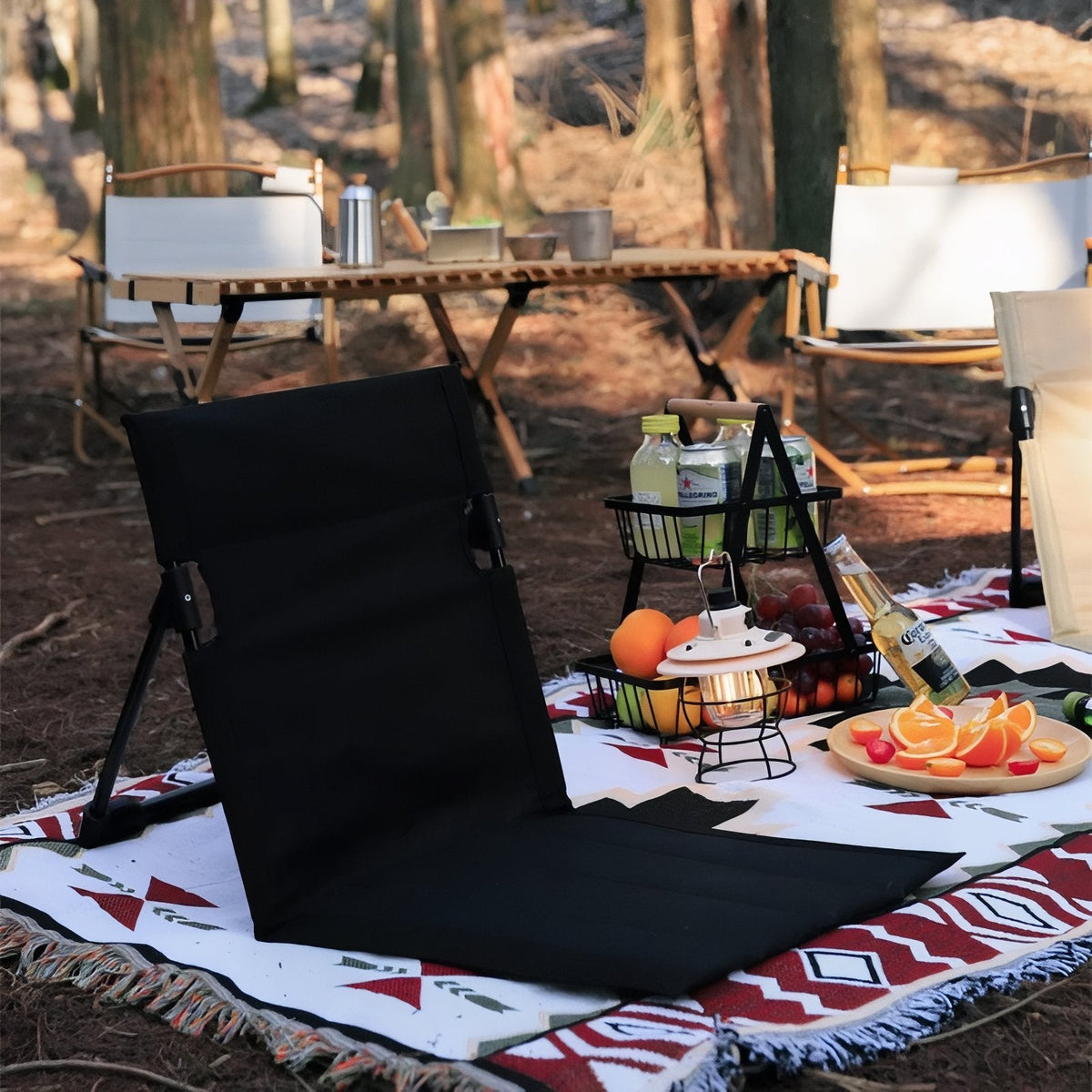 Black ground chair on a picnic rug at a campsite