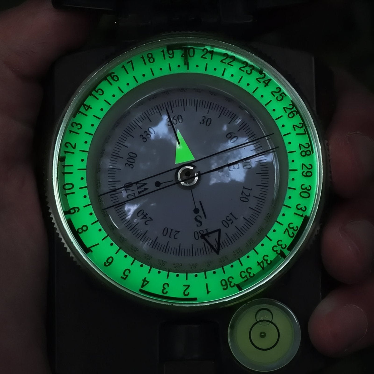Compass dial glowing green in the dark