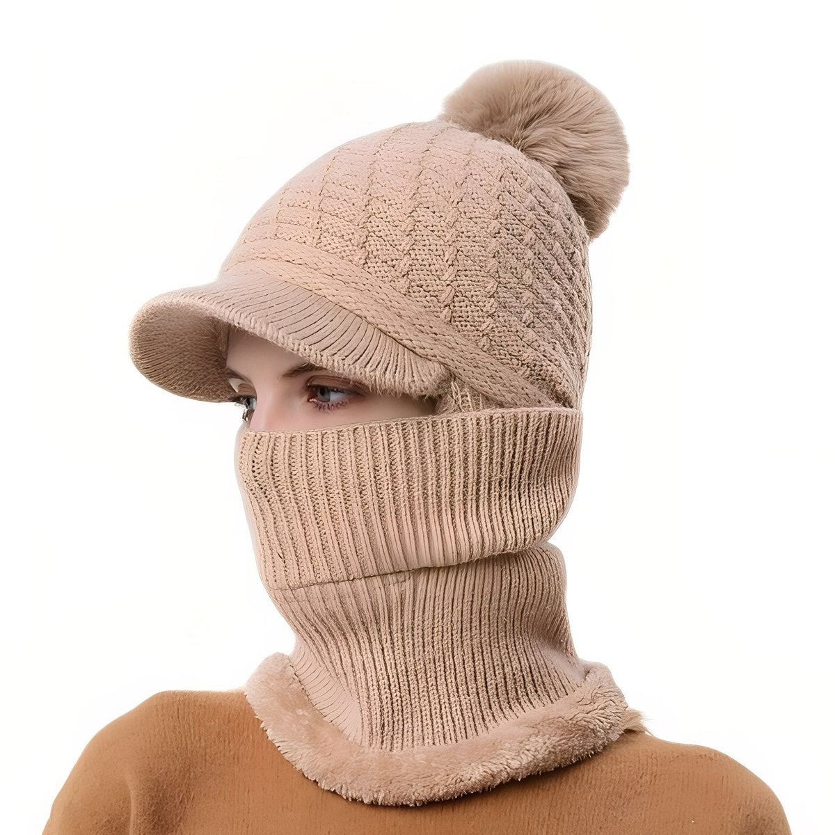 Taupe brim beanie with a pompom and the neck warmer pulled up over the face
