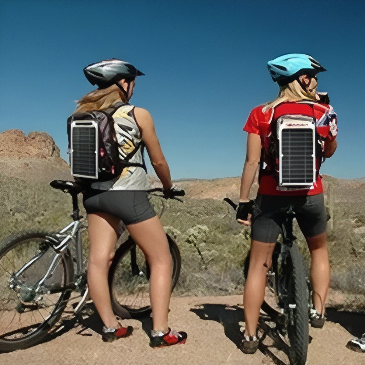 Two cyclists with the solar panel hanging on their backpacks