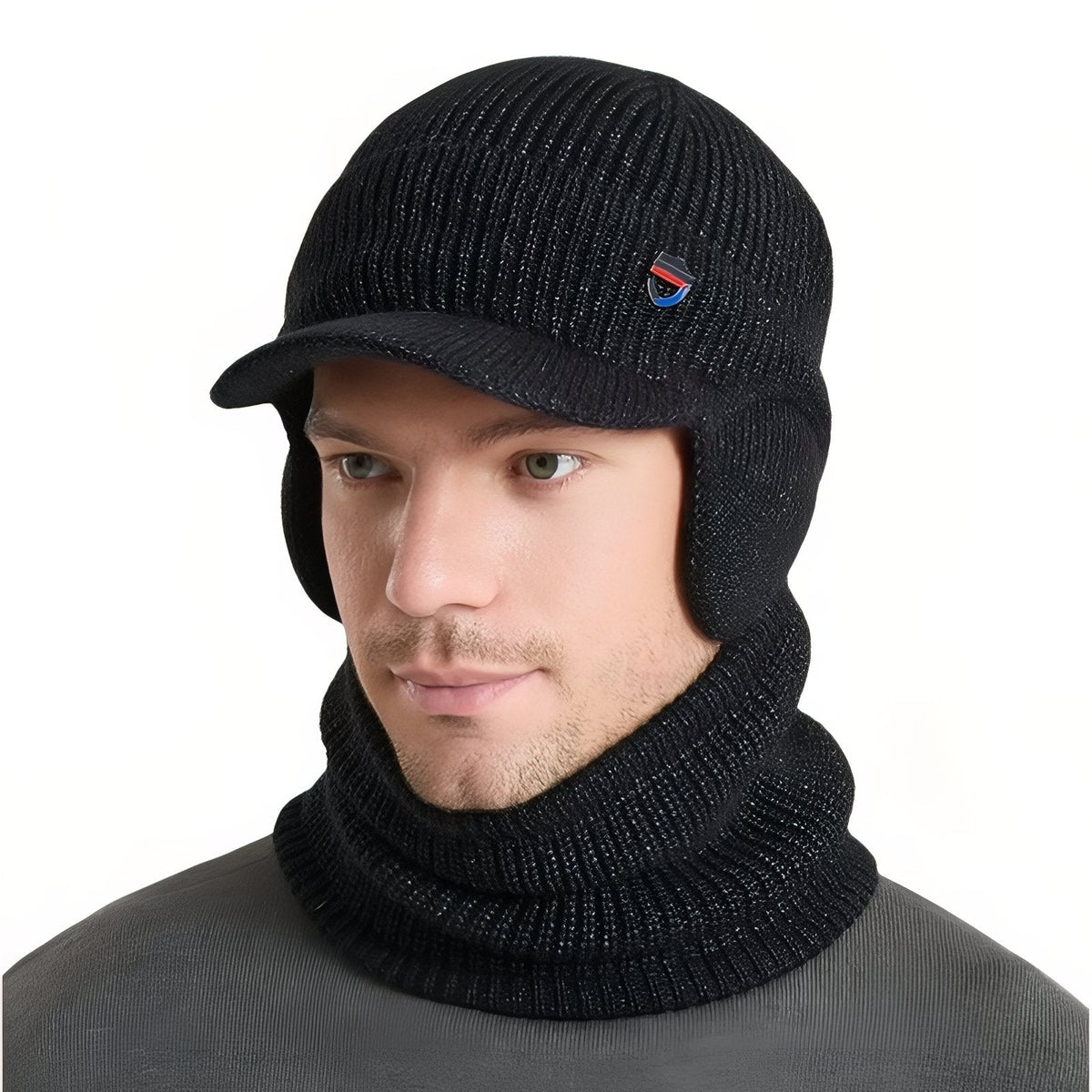Man wearing the black marl knit winter hat with brim and ear flaps and the matching neck warmer
