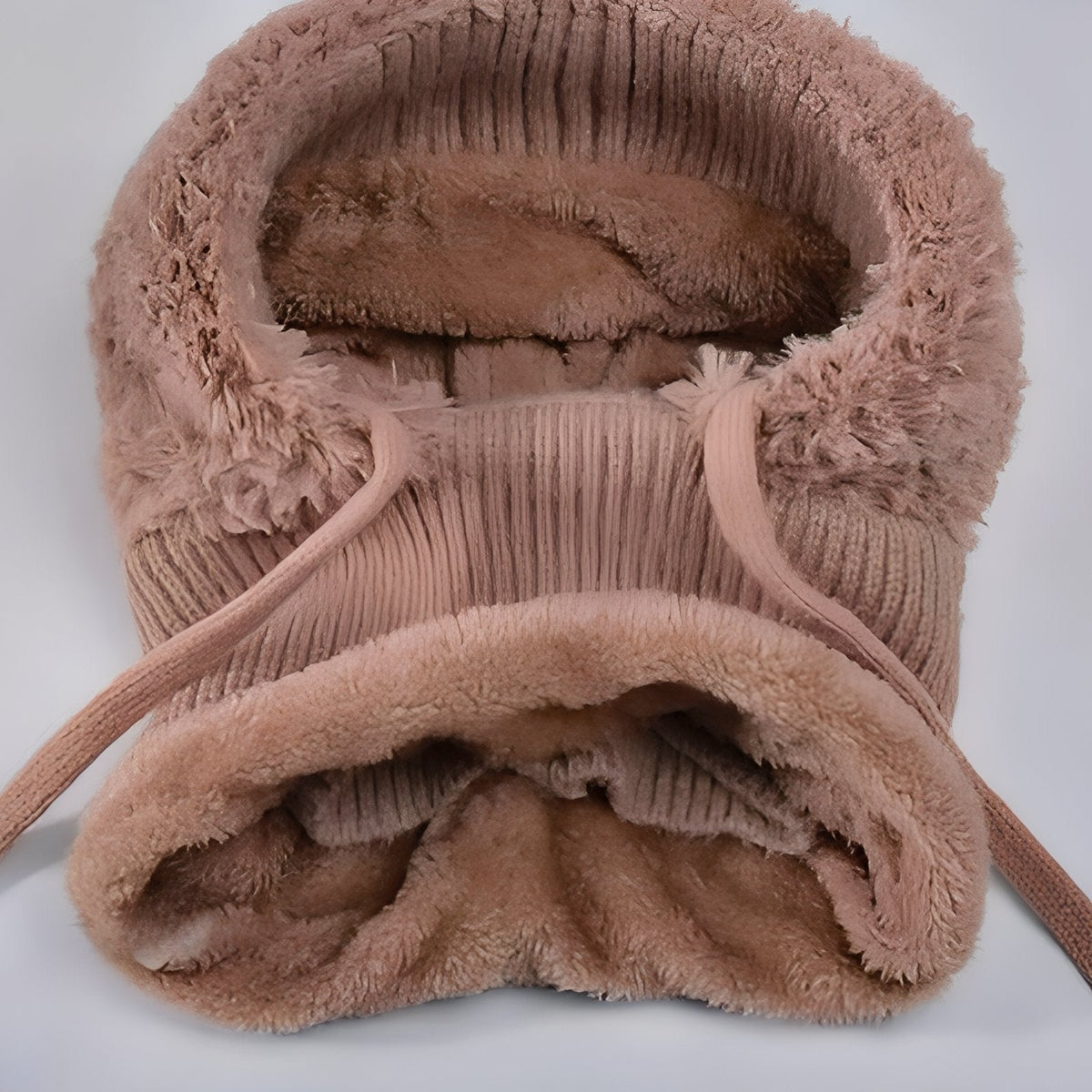 Inside of the brown balaclava hood showing the plush lining, rib-knit neck and drawcord