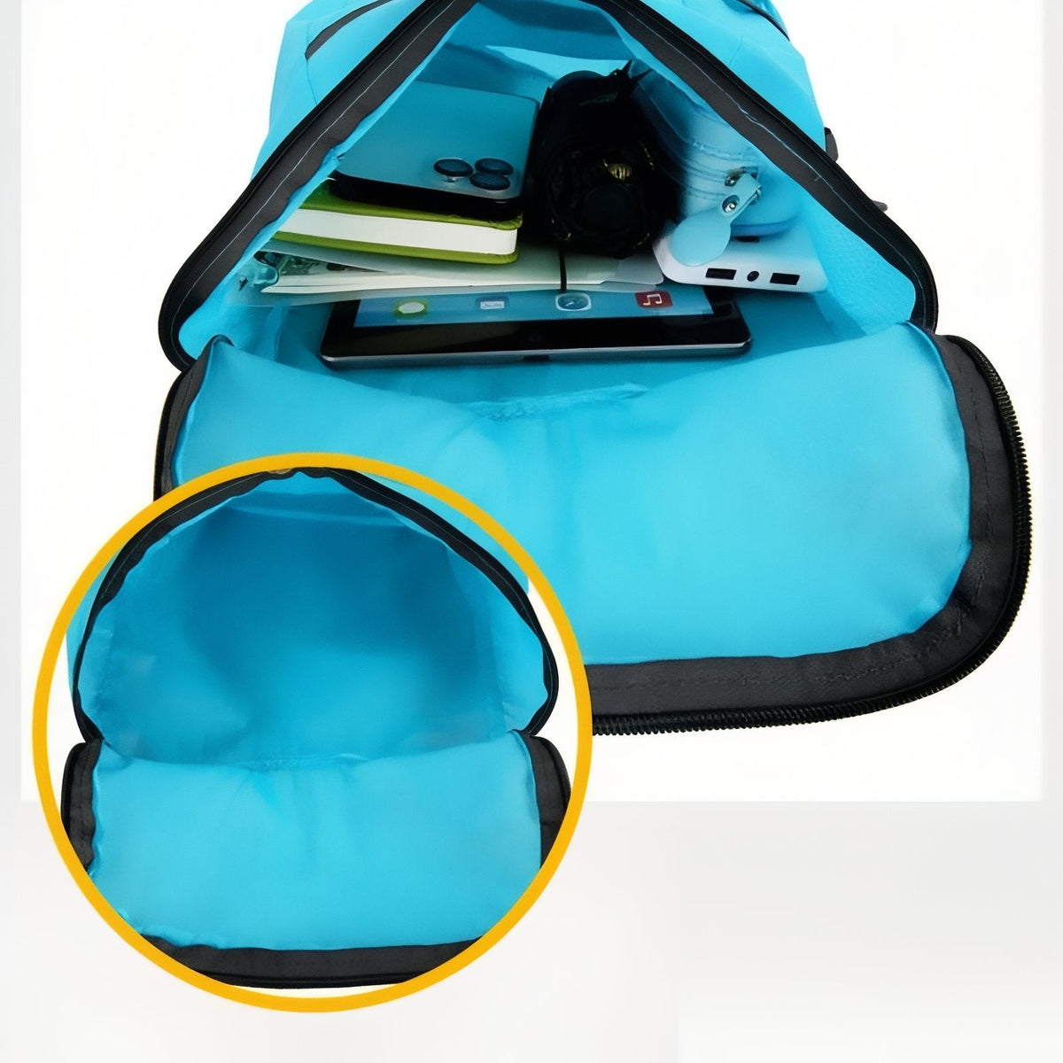The sky blue daypack opened to show the main compartment holding a notebook and small items