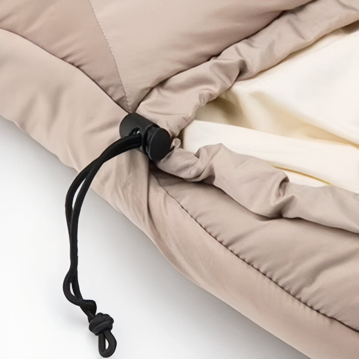 Close-up of the black drawcord and toggle that tighten the hood of the sleeping bag