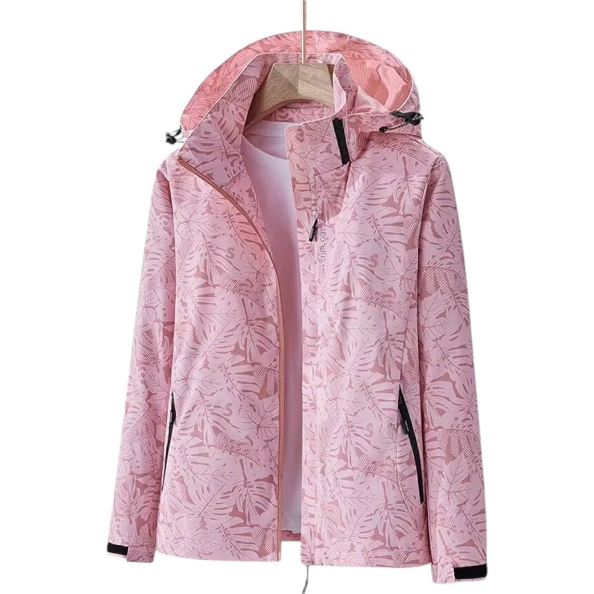 Pink leaf-print hooded hiking jacket hanging open on a wooden hanger