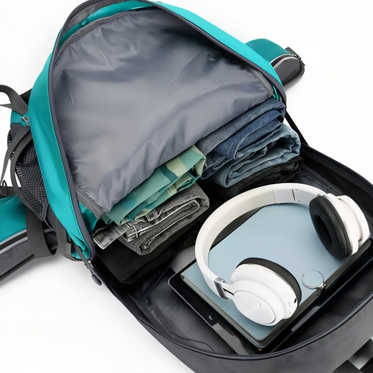 Main compartment opened, packed with clothes, headphones and a tablet