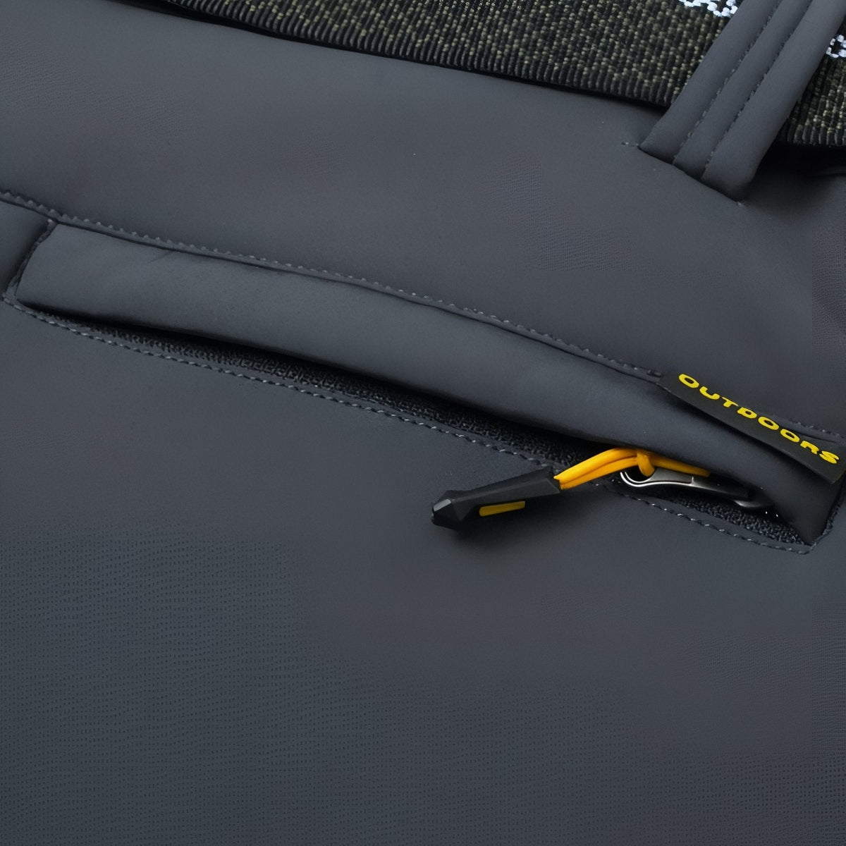 Close-up of the zipped hand pocket with a yellow zip pull on the slate grey trousers