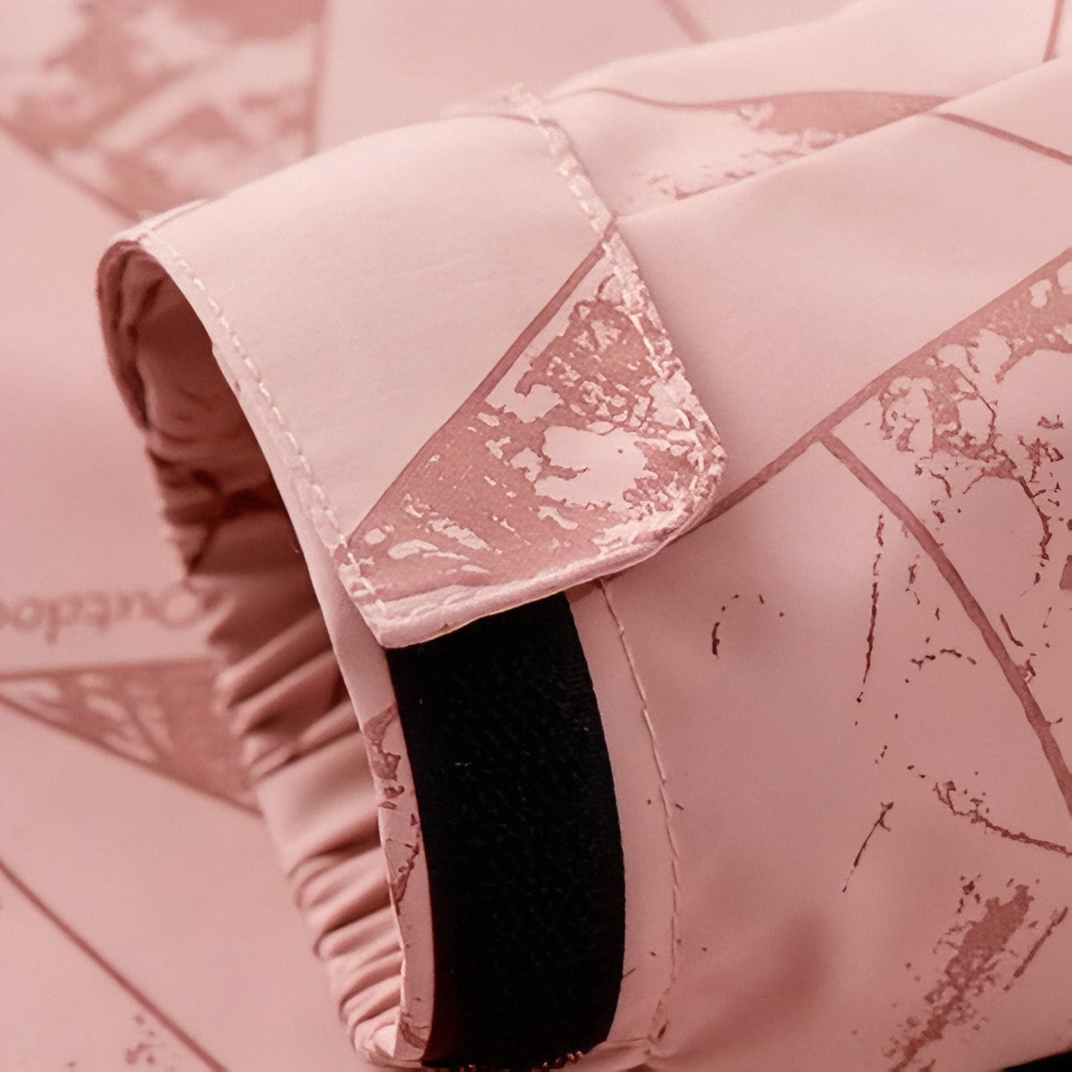 Close-up of the pink jacket's cuff with its elastic and adjustable tab