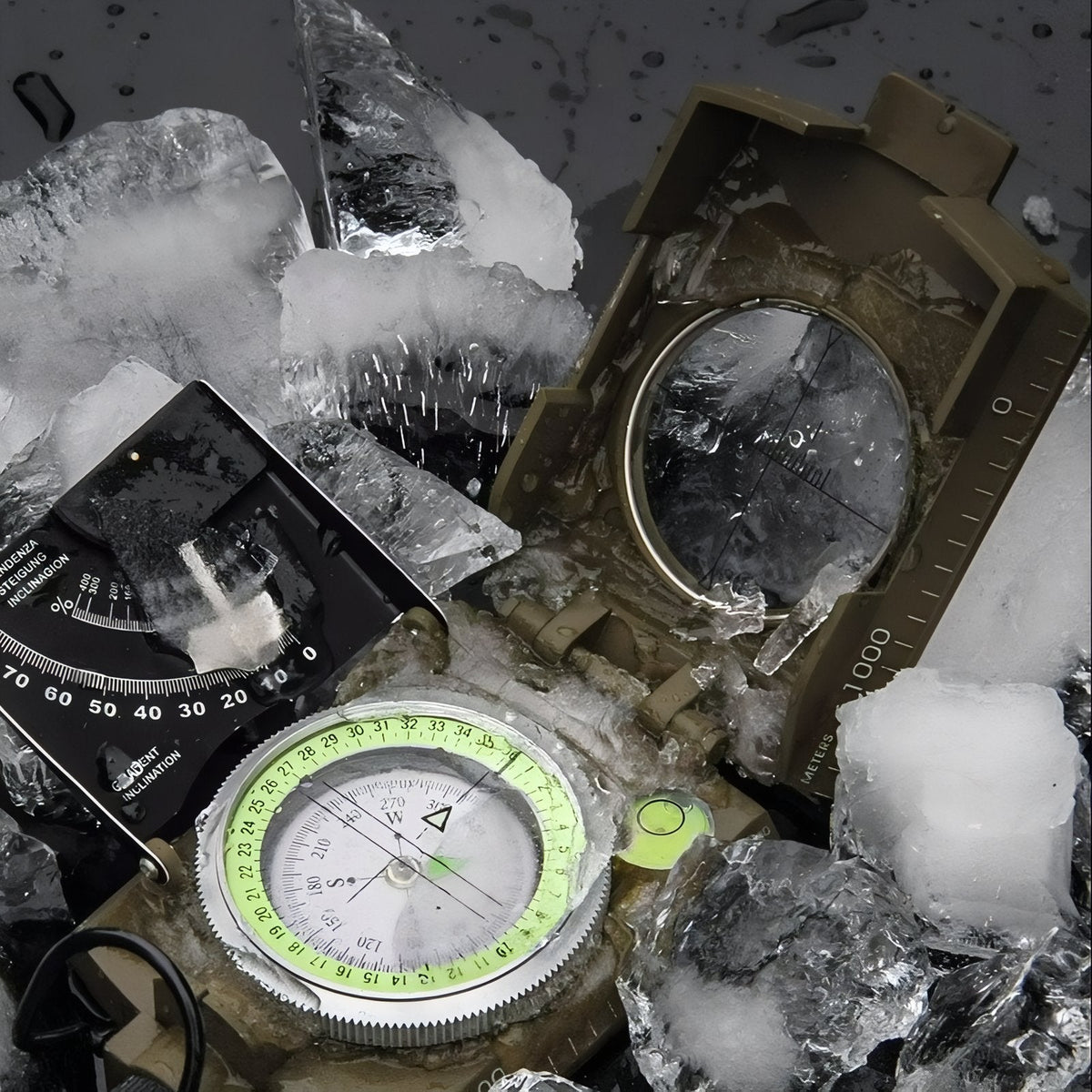 Sighting compass lying among ice chunks, water droplets on the green luminous dial and clinometer