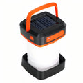 Orange and white collapsible solar lantern, open, on a white background