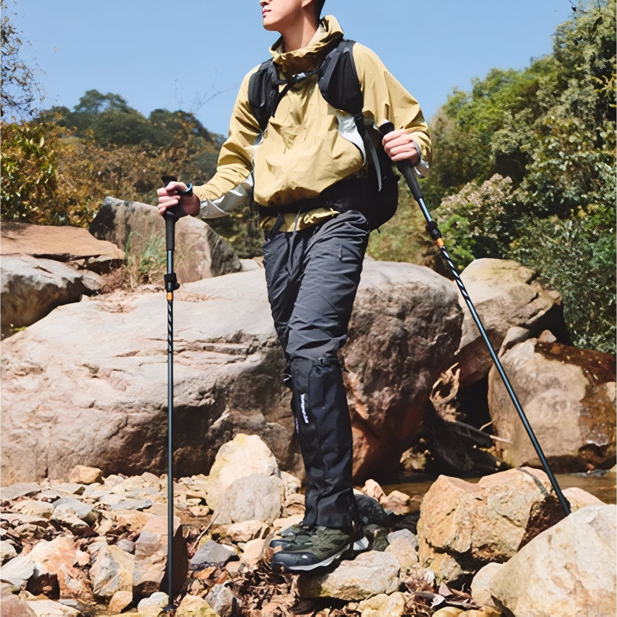 Walker standing on rocks with the trekking poles