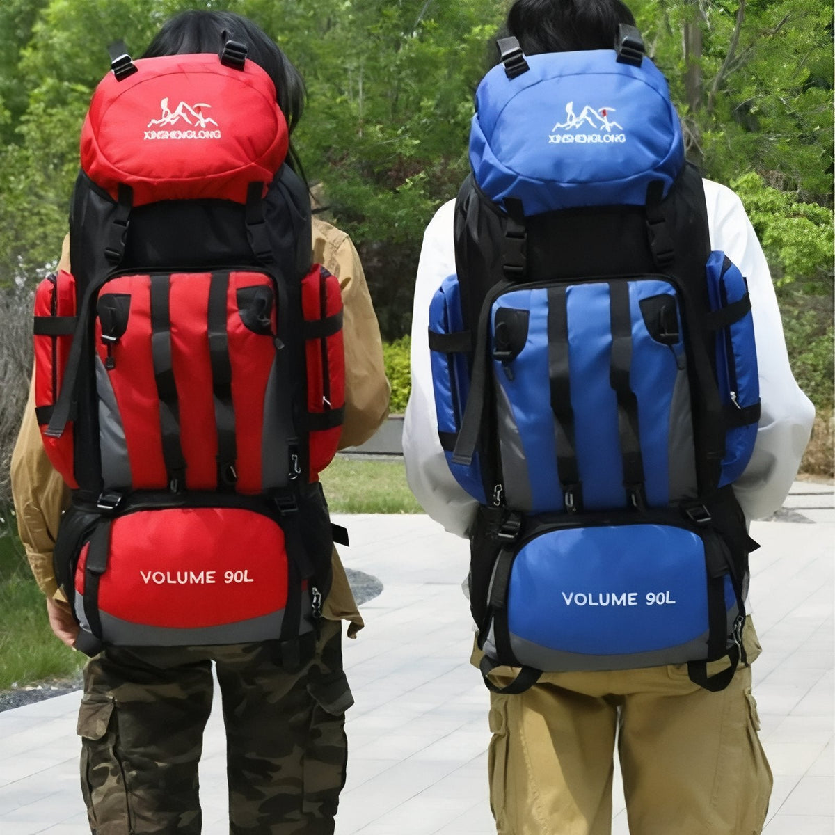 Two walkers carrying the red and the blue 90 L hiking backpack