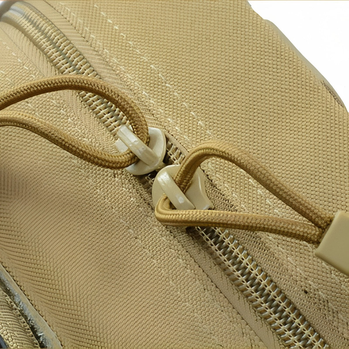Close-up of the khaki pouch's zip with cord zip pulls