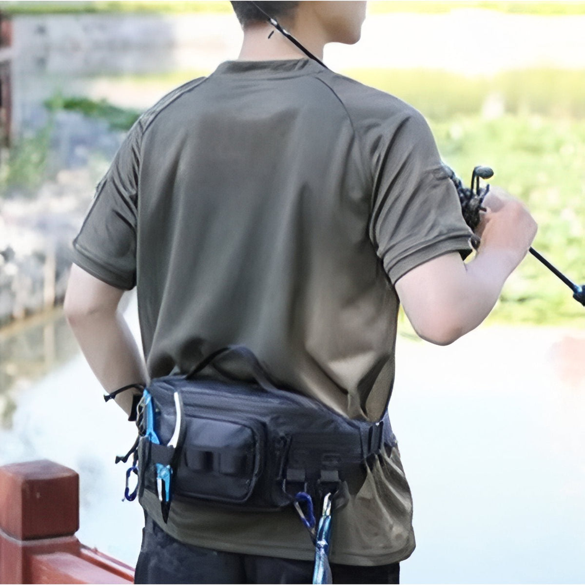 Man wearing a dark hip pack at the small of his back while fishing