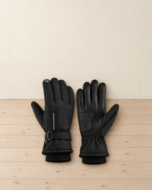 Pair of black fleece-lined winter hiking gloves with a zip pocket, wrist strap and knitted cuffs, one back up and one palm up on a pale pine floor