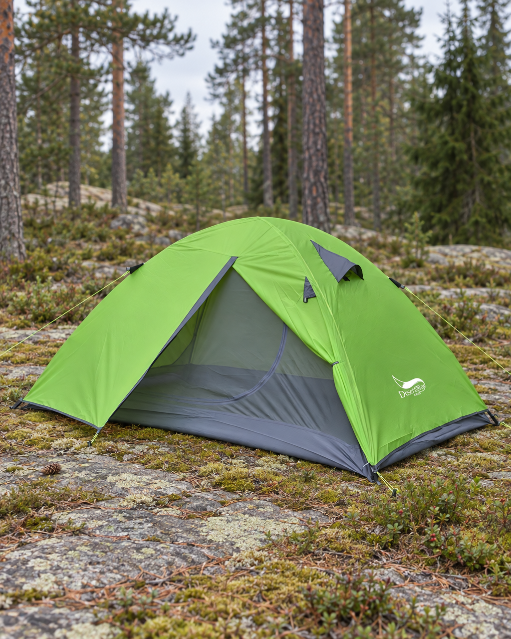 Lime green two-person dome tent pitched with guy lines out on moss and granite in a forest clearing, door open