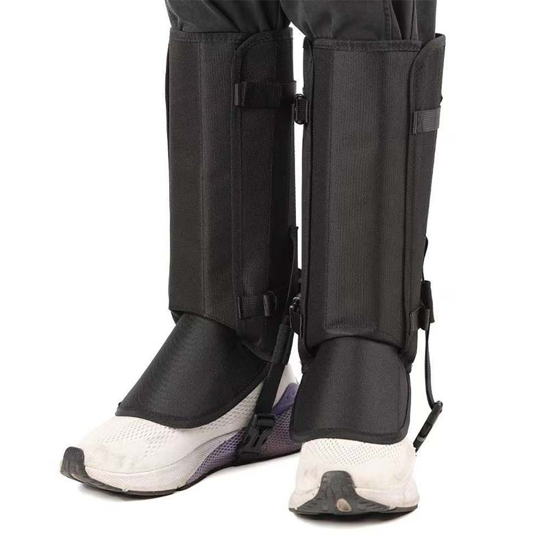 Black hiking gaiters worn over white trail shoes, front view