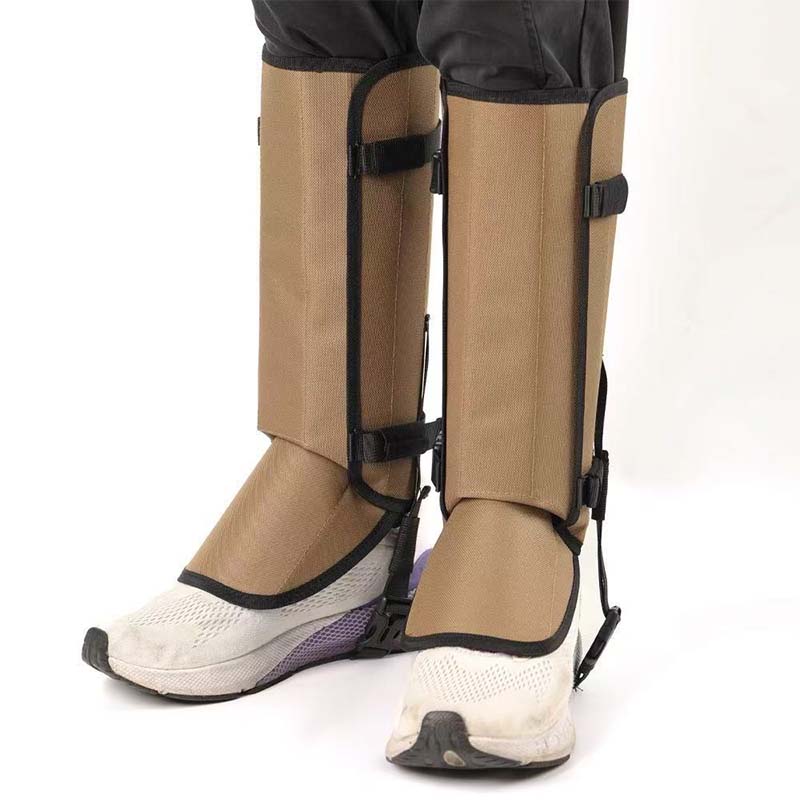 Khaki hiking gaiters worn over white trail shoes, front view